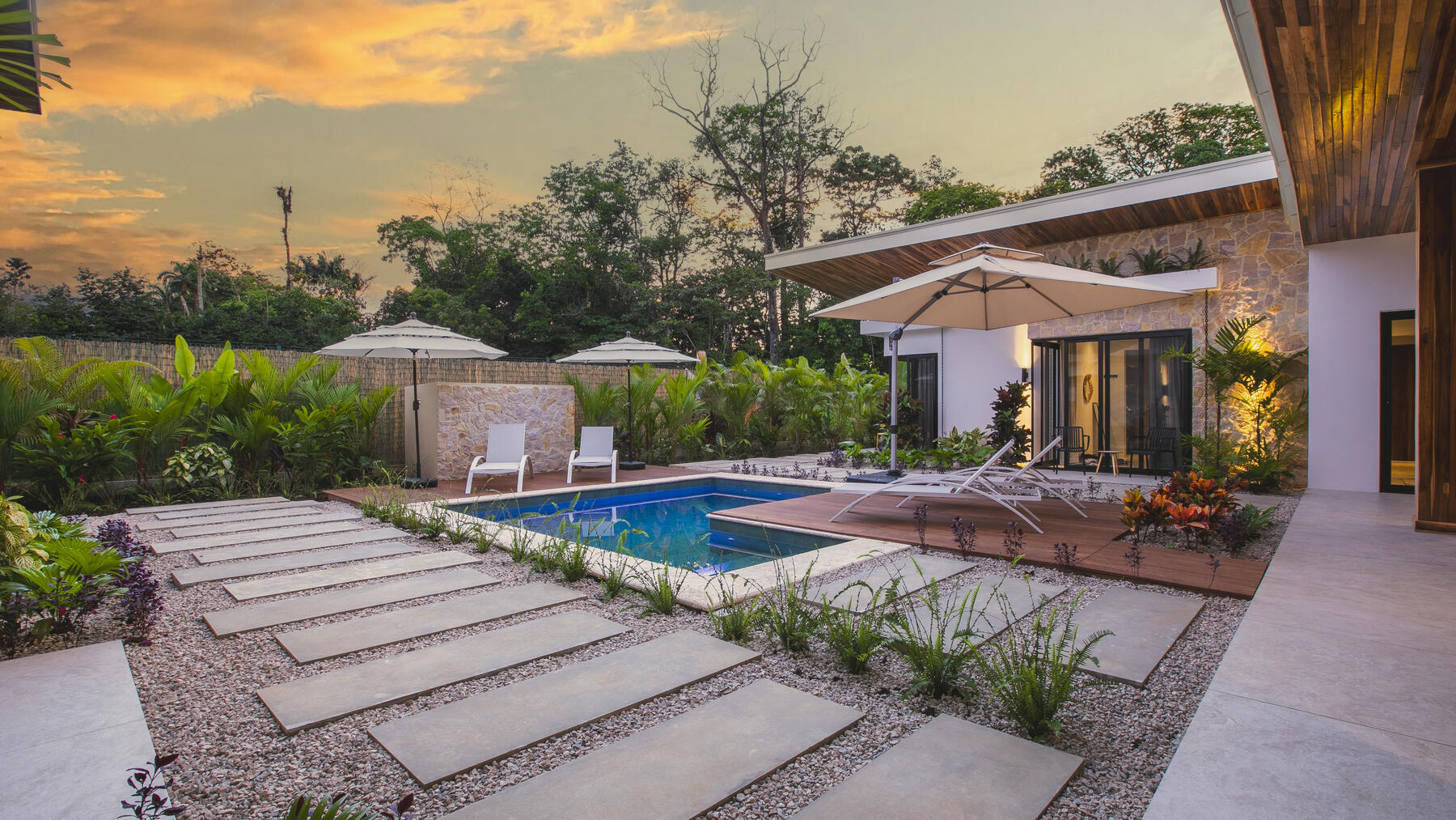 Private pool with loungers in tropical gardens